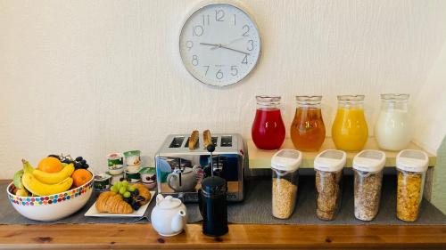 a kitchen counter with a clock and some food at Briscoe Lodge in Windermere