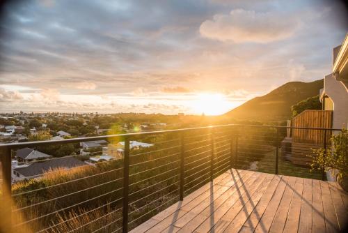 a view from the balcony of a house with the sunset at Ridge House in Hermanus