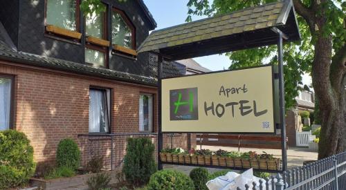 a sign for a hotel in front of a building at Hana Aparthotel in Hamburg