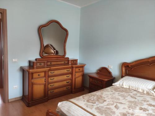 a bedroom with a dresser with a mirror on it at Il Castello - Casa nel cuore dell Abruzzo ideale per relax e montagna in Prata dʼAnsidonia