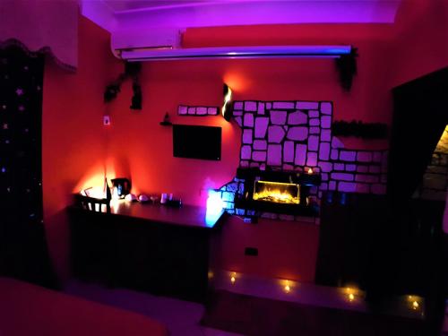 a room with a brick fireplace with a tv in it at B&B Ginevra 2 in Naples