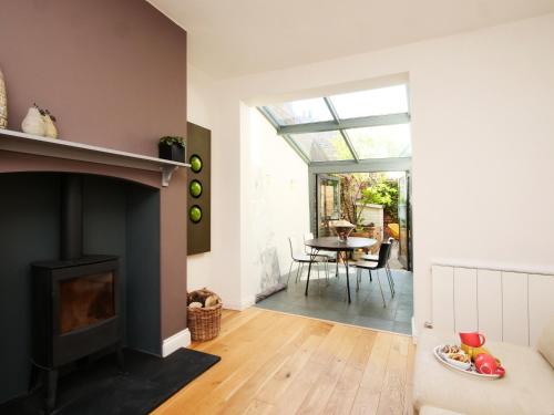 a living room with a fireplace and a table at Courtyard Cottage York - Free Parking in York