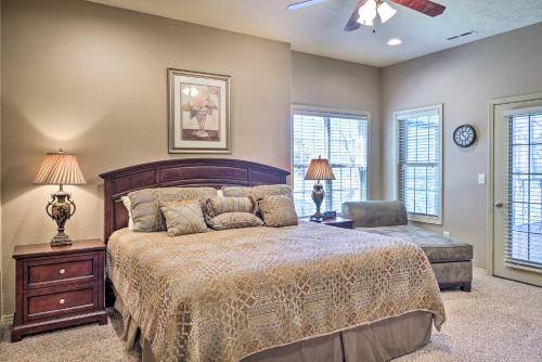 a bedroom with a bed and a chair and windows at Stonebridge Resort Condo Near Silver Dollar City! in Branson West