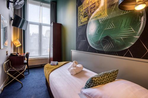 a hotel room with a bed and a chair at Hotel Alexander in Amsterdam