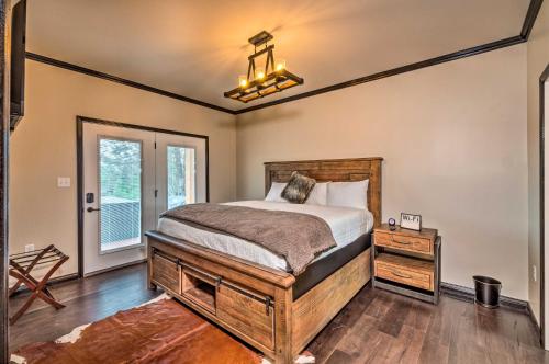 a bedroom with a bed and a table and a window at Tranquility Lake Getaway with Hot Tub on 27 Acres! in Columbia