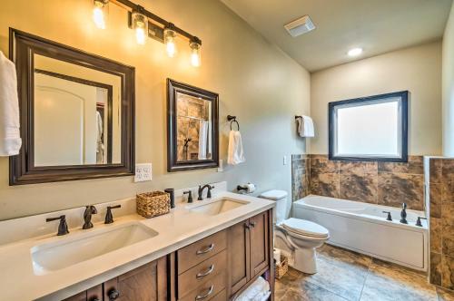 a bathroom with two sinks and a tub and a toilet at Tranquility Lake Getaway with Hot Tub on 27 Acres! in Columbia