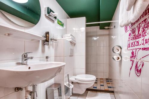 a bathroom with a sink and a toilet at Hotel Alexander in Amsterdam