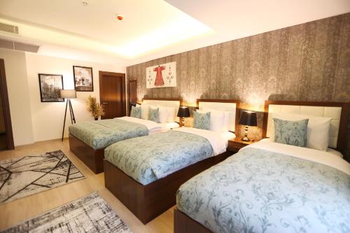a hotel room with two beds in a room at Cebeci Grand Hotel in Trabzon