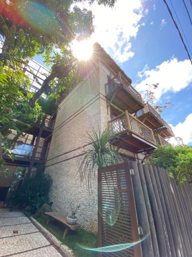 a building with a balcony on the side of it at Pousada Manga Rosa Beira Mar in Natal