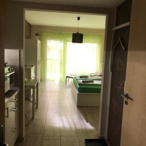 a bedroom with a bed and a window in a room at Velence Spa Apartman in Velence