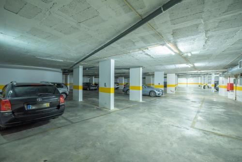 a parking garage with cars parked in it at Histórical City Center Penthouse Albufeira in Albufeira