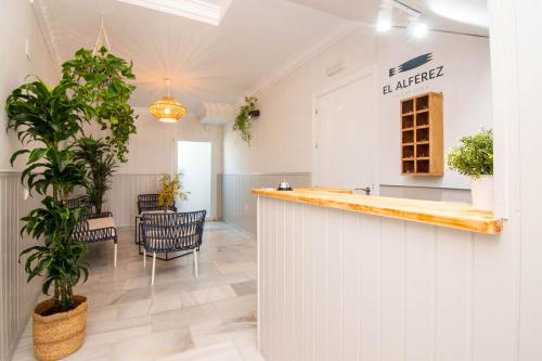 a bar in a room with a table and chairs at Hostal El Alférez in El Palmar
