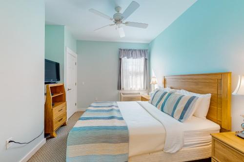 a bedroom with a large bed and a television at The Colonels Suites #4 and #5 in Northeast Harbor