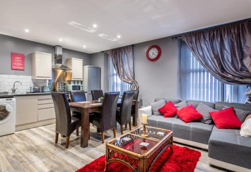 a living room with a couch and a table and a kitchen at Darlington Town Centre Apartments free parking and Wi-Fi in Darlington