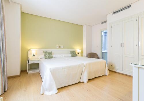 Postel nebo postele na pokoji v ubytování Hotel Platería