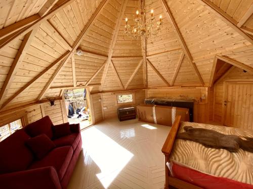 Zimmer im Dachgeschoss mit Sofa und Kronleuchter in der Unterkunft Woodland Lodge Mither Tap in Kintore