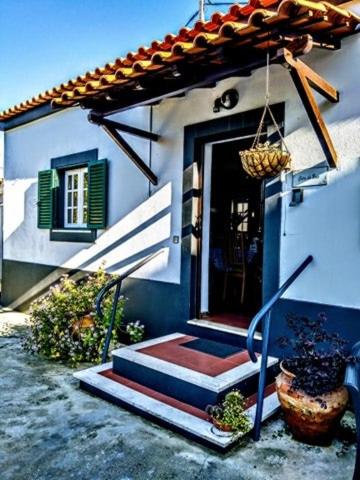 a house with a door and stairs leading to it at Páteo memória, casa do beco in Setúbal