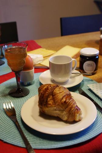 a table with a plate of croissant and a cup of coffee at Odiel & Gabrielle in Montchevrier