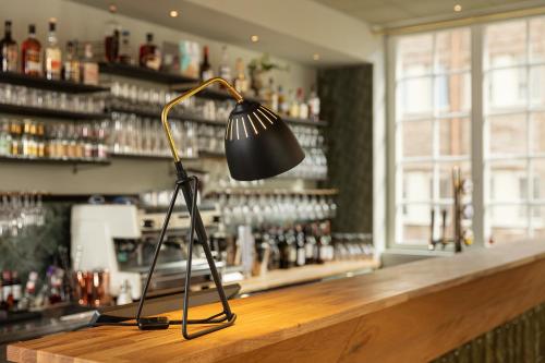 a lamp sitting on the counter of a bar at Nybro Stora Hotellet in Nybro