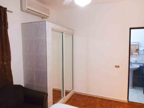 a room with a glass cabinet in the corner at Residence Tropical Garden in Boca Chica