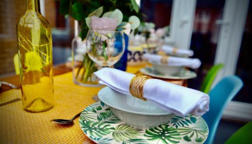 a table with a plate with a napkin on it at 5 Bedroom House - DISC0UNTS - Parking, Contractors, Group, Family in Canterbury