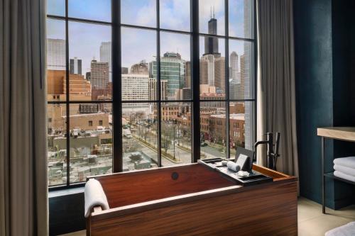a hotel room with a view of a city from a window at Nobu Hotel Chicago in Chicago