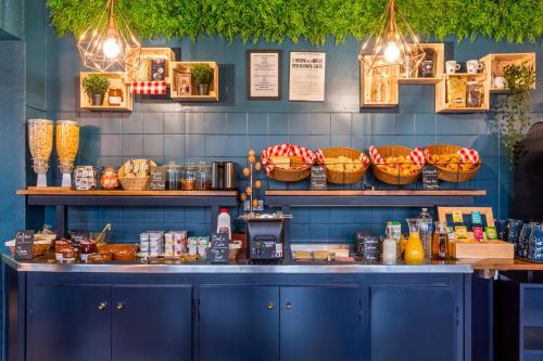 a counter in a restaurant with baskets on the wall at Sure Hotel by Best Western Calais Coquelles Tunnel s/ Manche in Coquelles