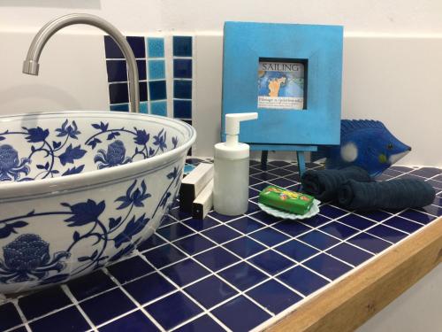 a bathroom counter with a sink and a bath tub at Experience Island Heritage Home in Pantai Kok