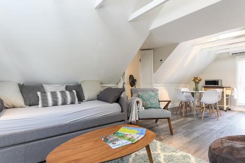 a living room with a couch and a table at Modern Duplex Downtown AC Walkable in Traverse City
