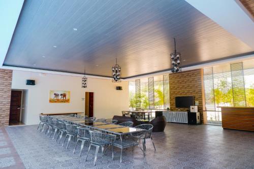 a large room with tables and chairs in it at Armando's Garden Resort and Restaurant in Anao