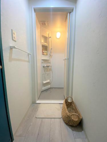 an empty refrigerator with its door open in a room at Hostel Anchorage in Kobe