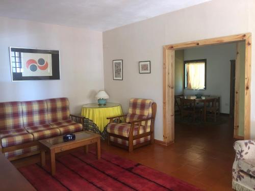 a living room with couches and chairs and a table at Casa Valverde in Cartaxo