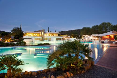 a large swimming pool at a resort at night at Camping Village Rocchette in Castiglione della Pescaia