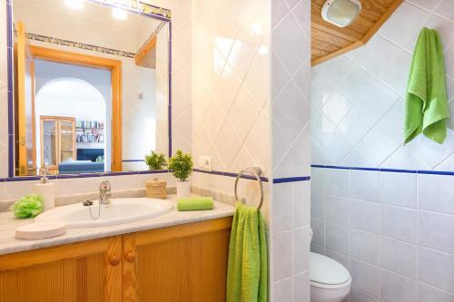 a bathroom with a sink and a mirror at Villa Girasol by Villa Plus in Alaior