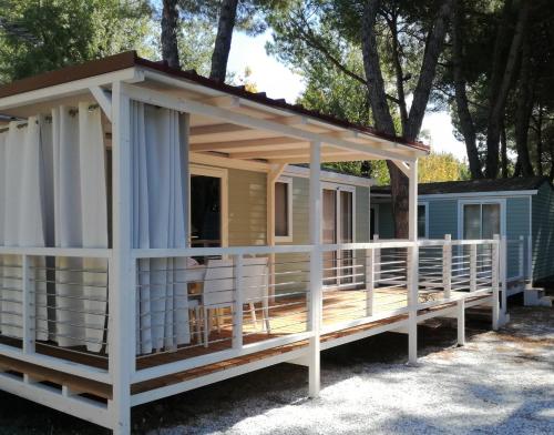 a house with awning on a deck at Campeggio Italia in Marina di Massa