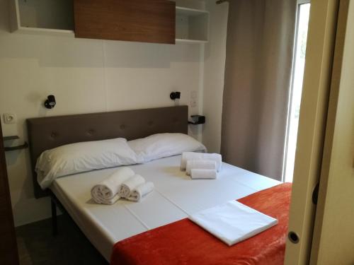a bedroom with a bed with towels on it at Campeggio Italia in Marina di Massa