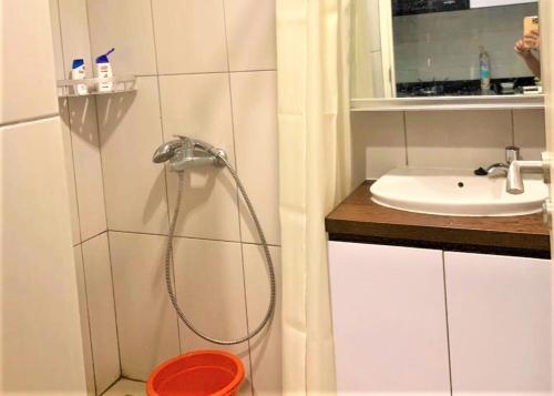 a bathroom with a shower and a sink at Grand Kamala Lagoon by Veeroom in Pekayon Satu