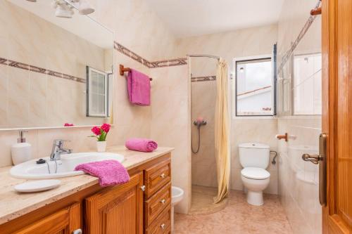 a bathroom with a sink and a toilet and a shower at Villa Xaloc Blanes by Villa Plus in Cala Blanca