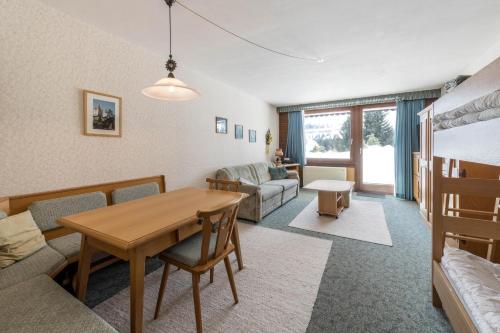 a living room with a table and a couch at Haus Kreidl - Top 7 in Königsleiten