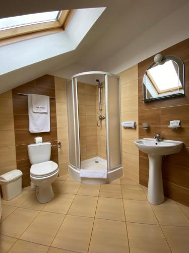 a bathroom with a toilet and a sink at Hotel Marand in Rzeszów