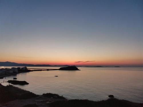 a sunset over a body of water at Hotel Grotta in Naxos Chora