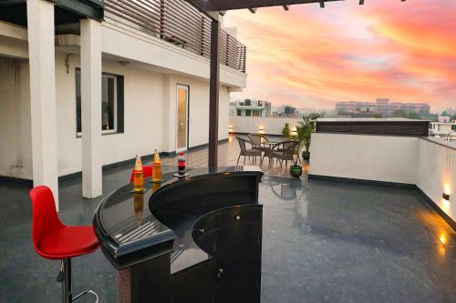a balcony with a bar on top of a building at FabHotel La Paz Stay B&B in New Delhi