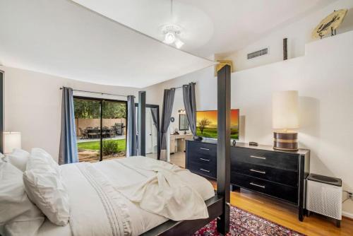 a bedroom with a bed and a dresser and a window at Beautiful Scottsdale Escape Heated Pool, Spa, & Putting Green in Phoenix