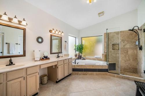 a bathroom with a tub and a sink and a shower at Beautiful Scottsdale Escape Heated Pool, Spa, & Putting Green in Phoenix