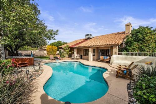 a swimming pool in the backyard of a house at Beautiful Scottsdale Escape Heated Pool, Spa, & Putting Green in Phoenix