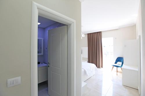 a room with a door leading to a bedroom at Hotel Mare in Ksamil
