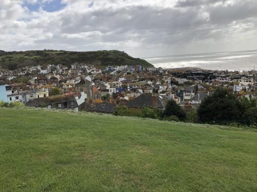 a view of a town from a hill with a green field at Astral Lodge in Hastings