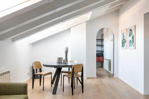 a dining room with a table and chairs at Aspasios Calle Mayor Apartments in Madrid