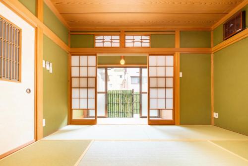 an empty room with a door and windows at TEMARI in Hakone