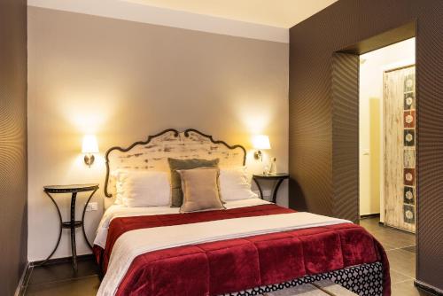 a bedroom with a large bed and two tables at Il Giardino di Ballarò Boutique B&B in Palermo